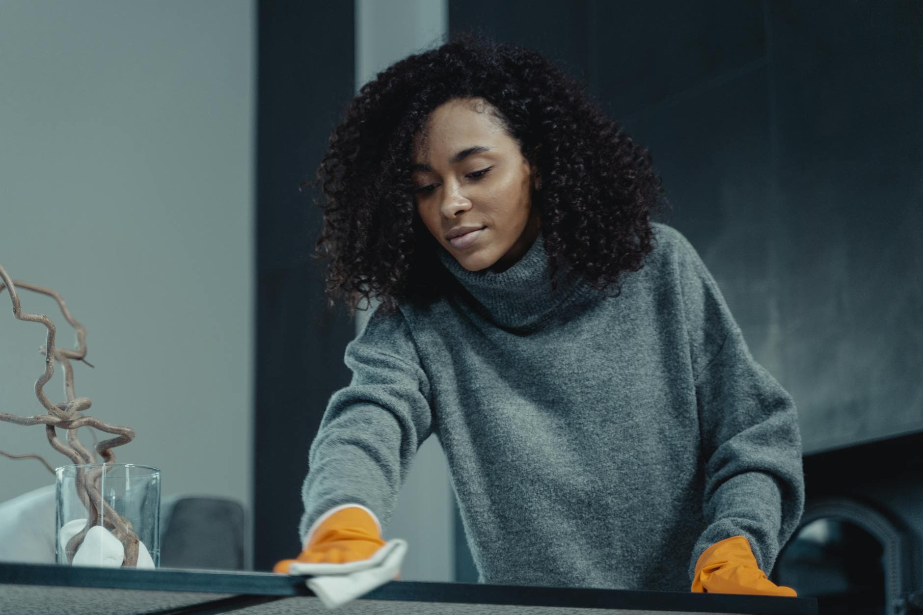 Your Business cleaner wiping a table in a New York City apartment — cleaning services in Rye, Westchester